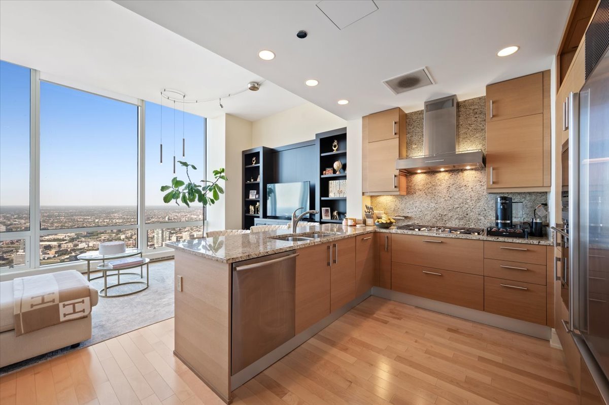 401 North Wabash Avenue, Unit 71C Chicago, IL 60611 - Photo 5 of 38 a kitchen with stainless steel appliances kitchen island granite countertop a stove and cabinets