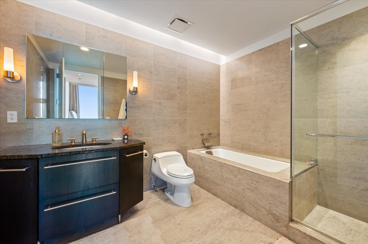 401 North Wabash Avenue, Unit 71C Chicago, IL 60611 - Photo 10 of 38 a bathroom with a sink a toilet and shower