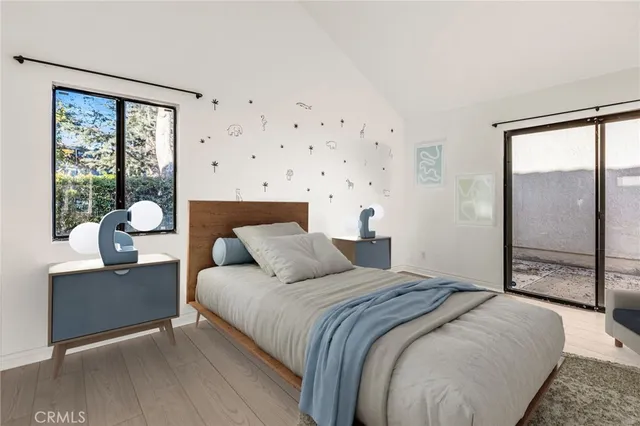 a bedroom with a large bed and a large window