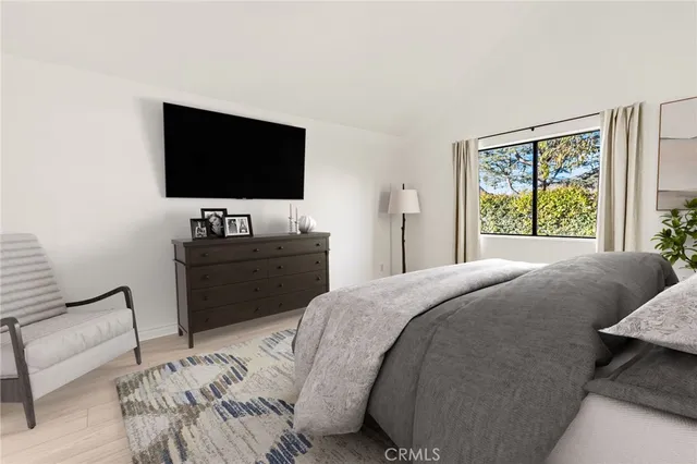 a bedroom with a bed and a flat screen tv