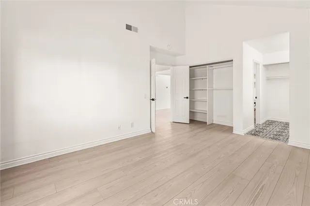 a view of an empty room and wooden floor
