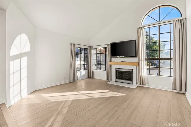 a view of a livingroom with a fireplace window and a fireplace