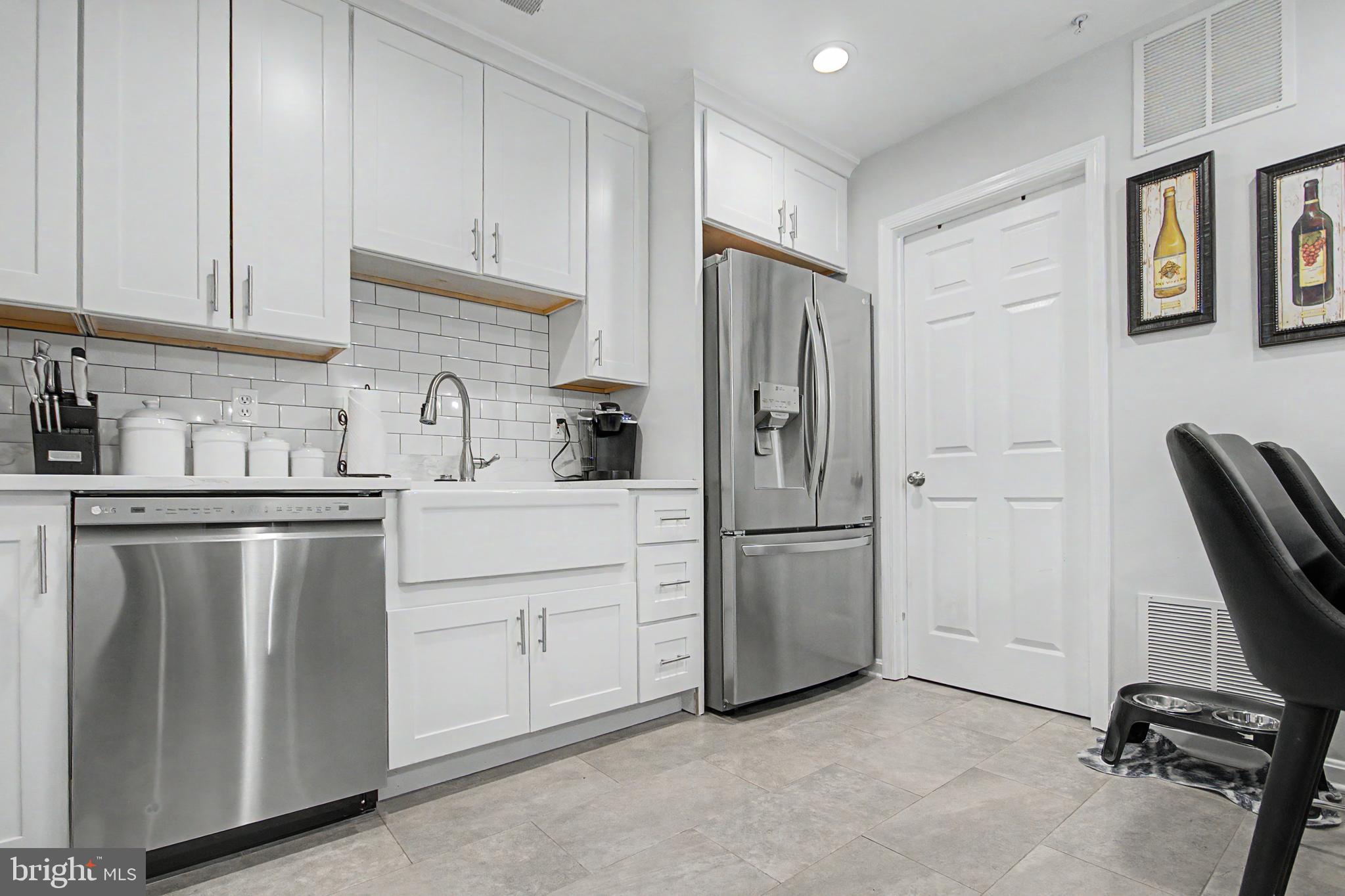 2607 Compass Drive Annapolis, MD 21401 - Photo 11 of 61 a kitchen with a refrigerator sink and cabinets