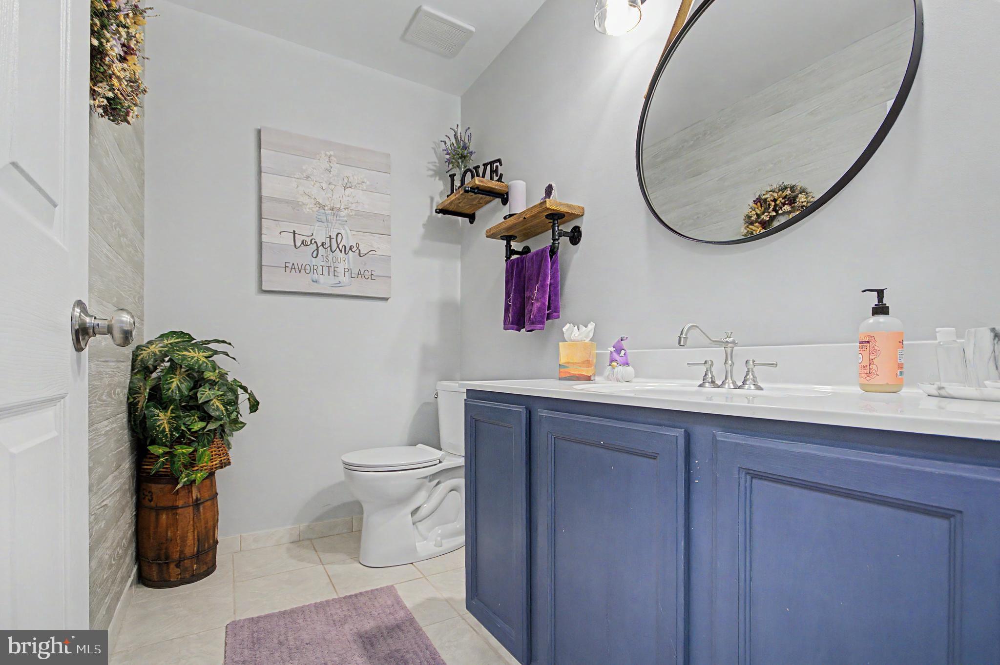 2607 Compass Drive Annapolis, MD 21401 - Photo 29 of 61 a bathroom with a toilet sink vanity and mirror