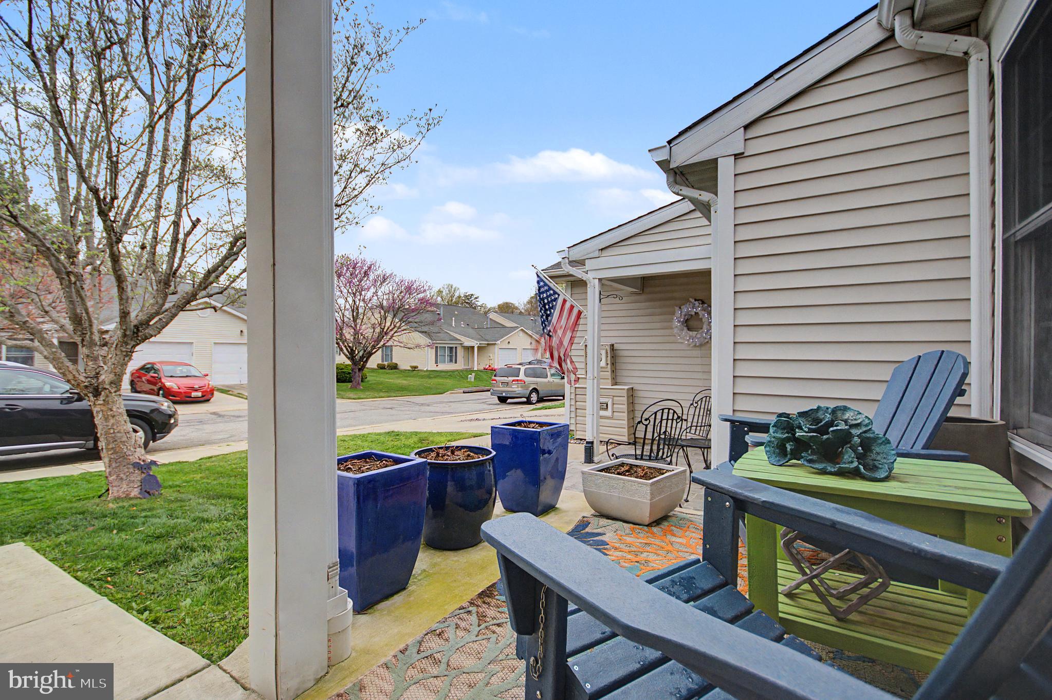 2607 Compass Drive Annapolis, MD 21401 - Photo 4 of 61 a view of a patio with table and chairs potted plants and a large tree