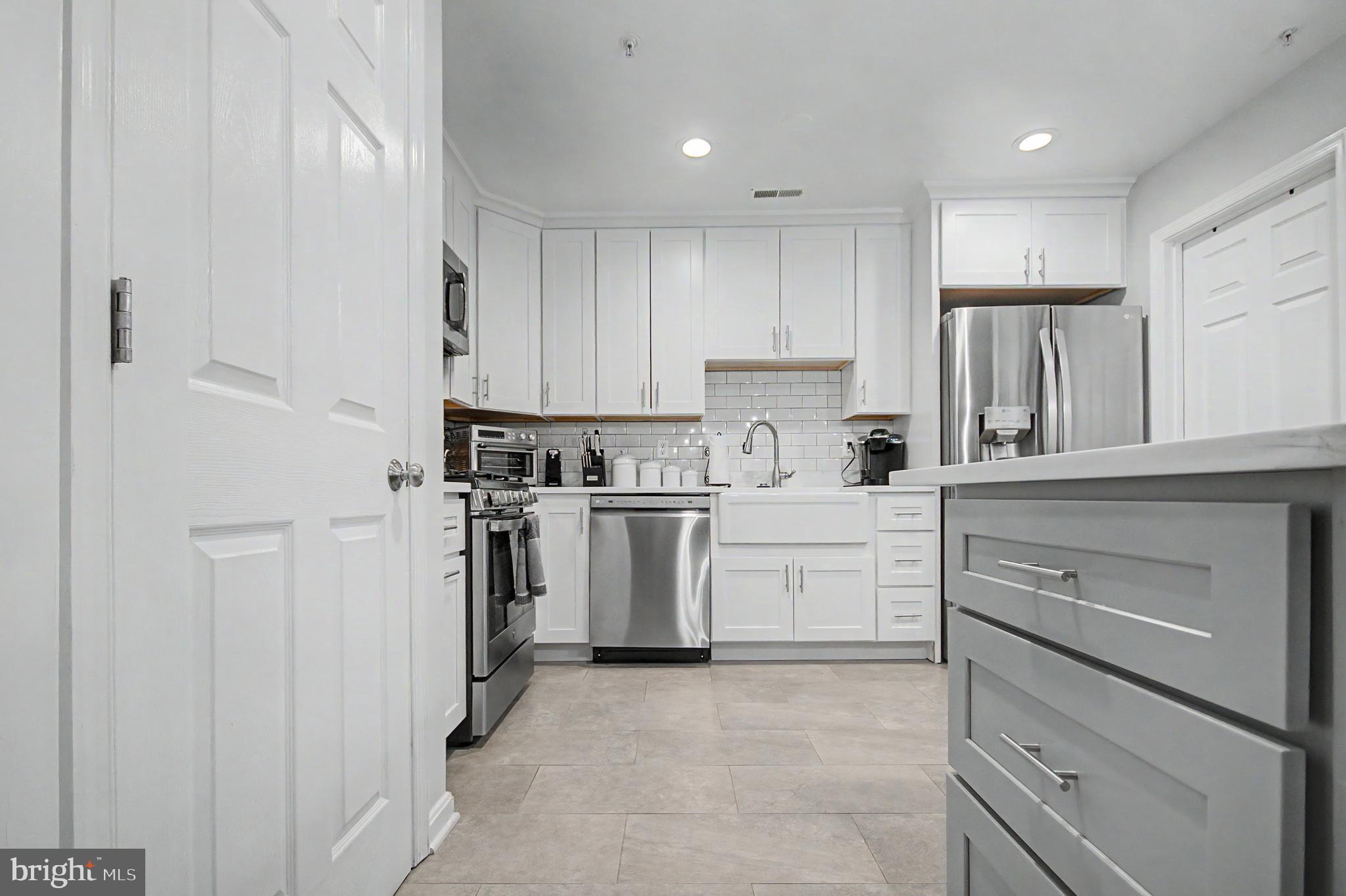 2607 Compass Drive Annapolis, MD 21401 - Photo 5 of 61 a kitchen with white cabinets and stainless steel appliances
