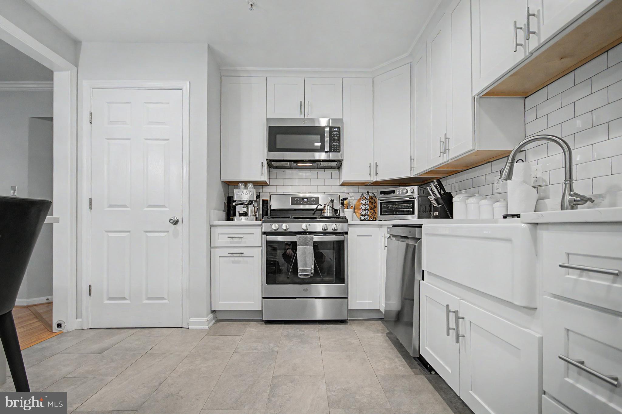 2607 Compass Drive Annapolis, MD 21401 - Photo 6 of 61 a kitchen with white cabinets and stainless steel appliances