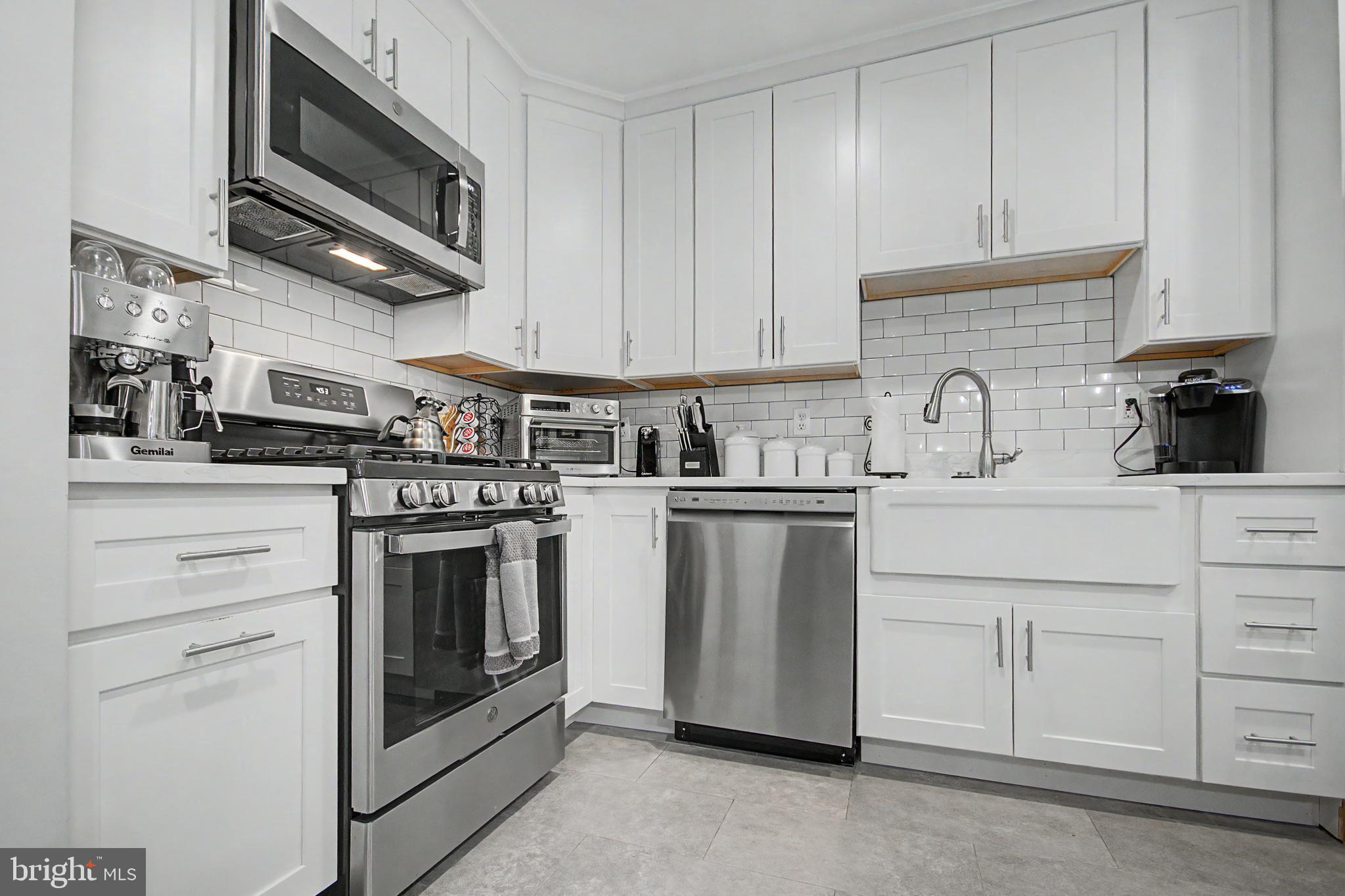 2607 Compass Drive Annapolis, MD 21401 - Photo 8 of 61 a kitchen with white cabinets stainless steel appliances and sink