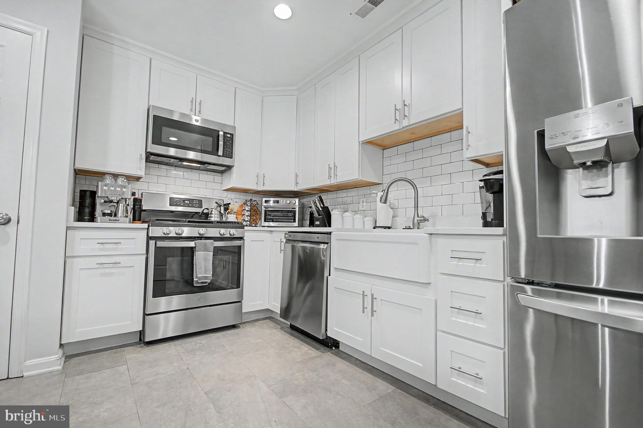 2607 Compass Drive Annapolis, MD 21401 - Photo 10 of 61 a kitchen with white cabinets stainless steel appliances and sink