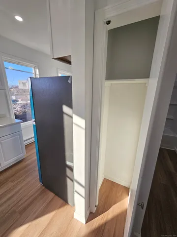 a view of refrigerator and wooden floor