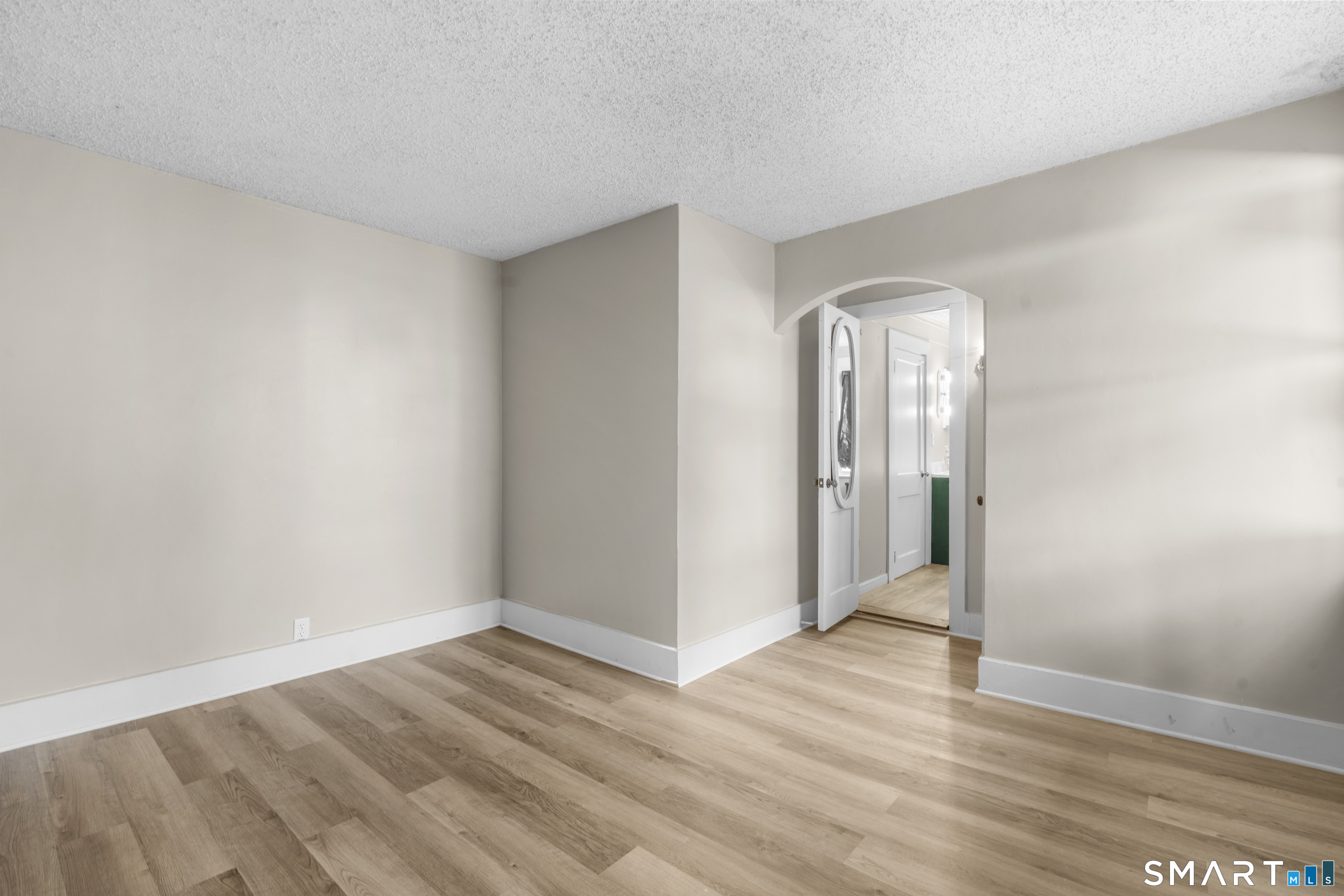 301 Queen Street Bristol, CT 06010 - Photo 11 of 26 an empty room with wooden floor and a window
