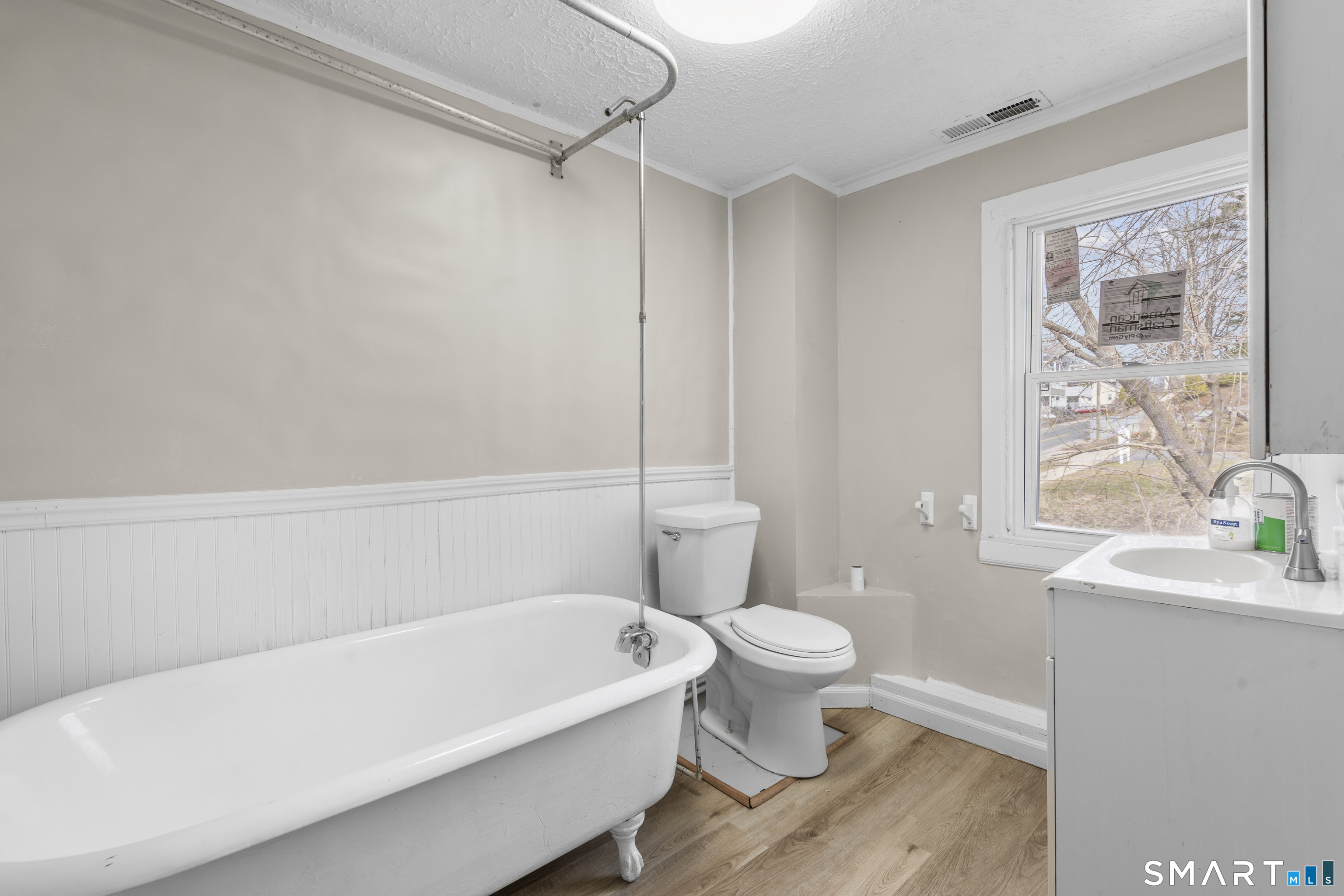 301 Queen Street Bristol, CT 06010 - Photo 17 of 26 a white bath tub sitting next to a white toilet