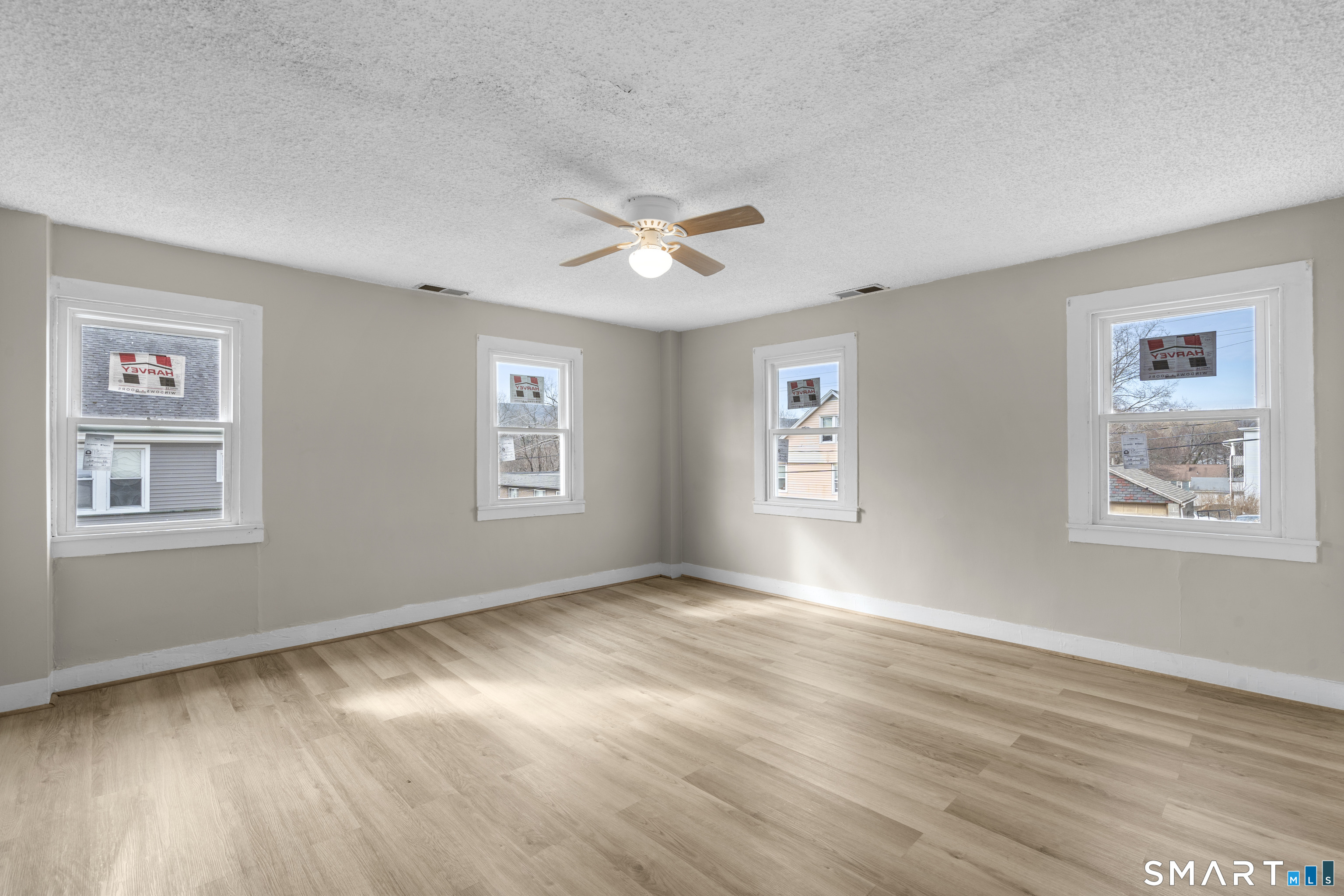 301 Queen Street Bristol, CT 06010 - Photo 18 of 26 a view of an empty room with a window and wooden floor