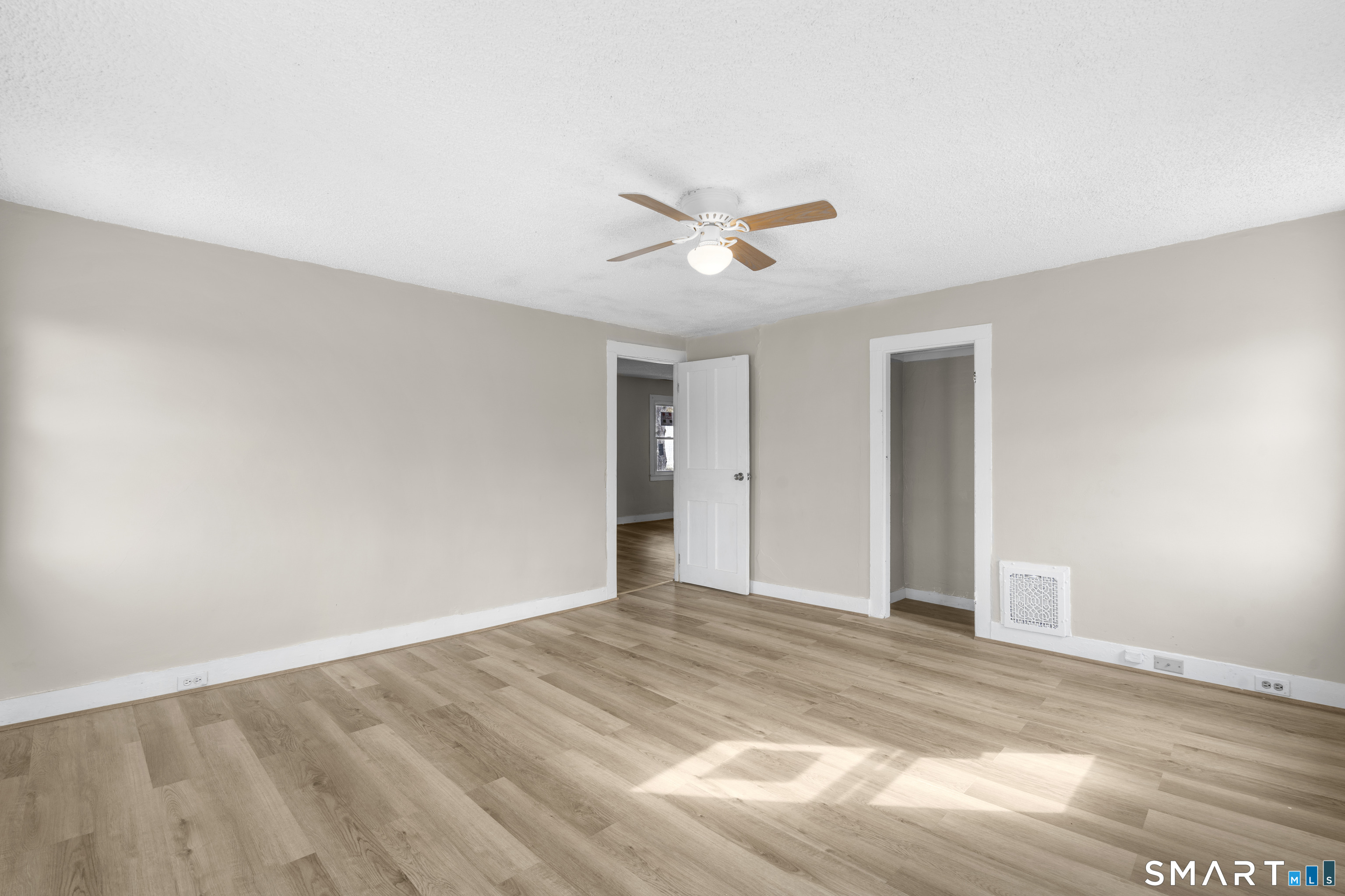 301 Queen Street Bristol, CT 06010 - Photo 19 of 26 a view of a big room with wooden floor and a ceiling fan