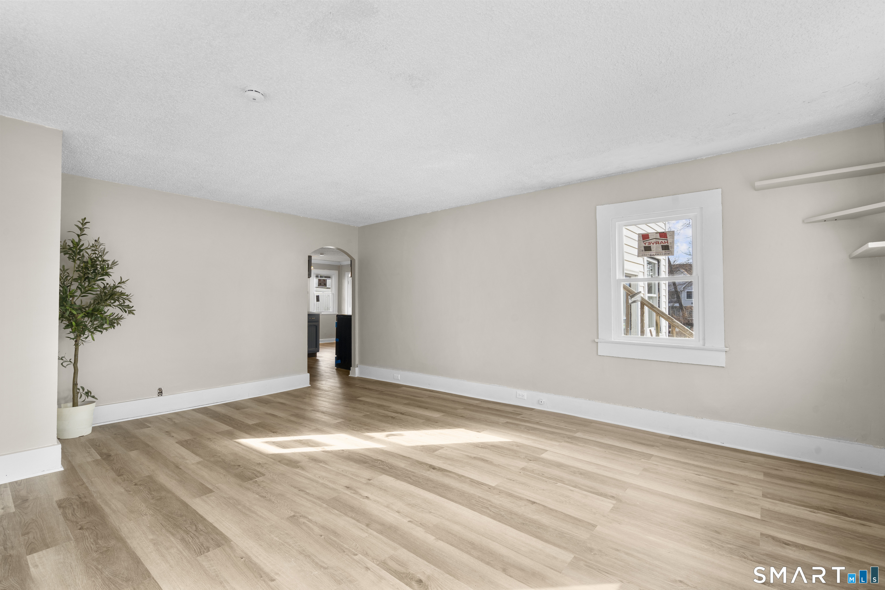 301 Queen Street Bristol, CT 06010 - Photo 6 of 26 a view of an empty room with window and wooden floor