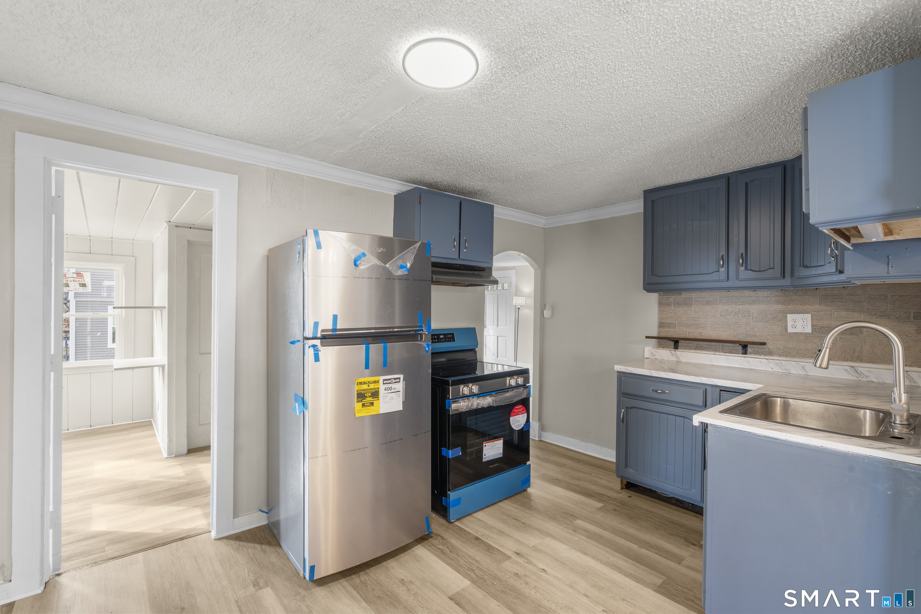301 Queen Street Bristol, CT 06010 - Photo 8 of 26 a kitchen with refrigerator and cabinets