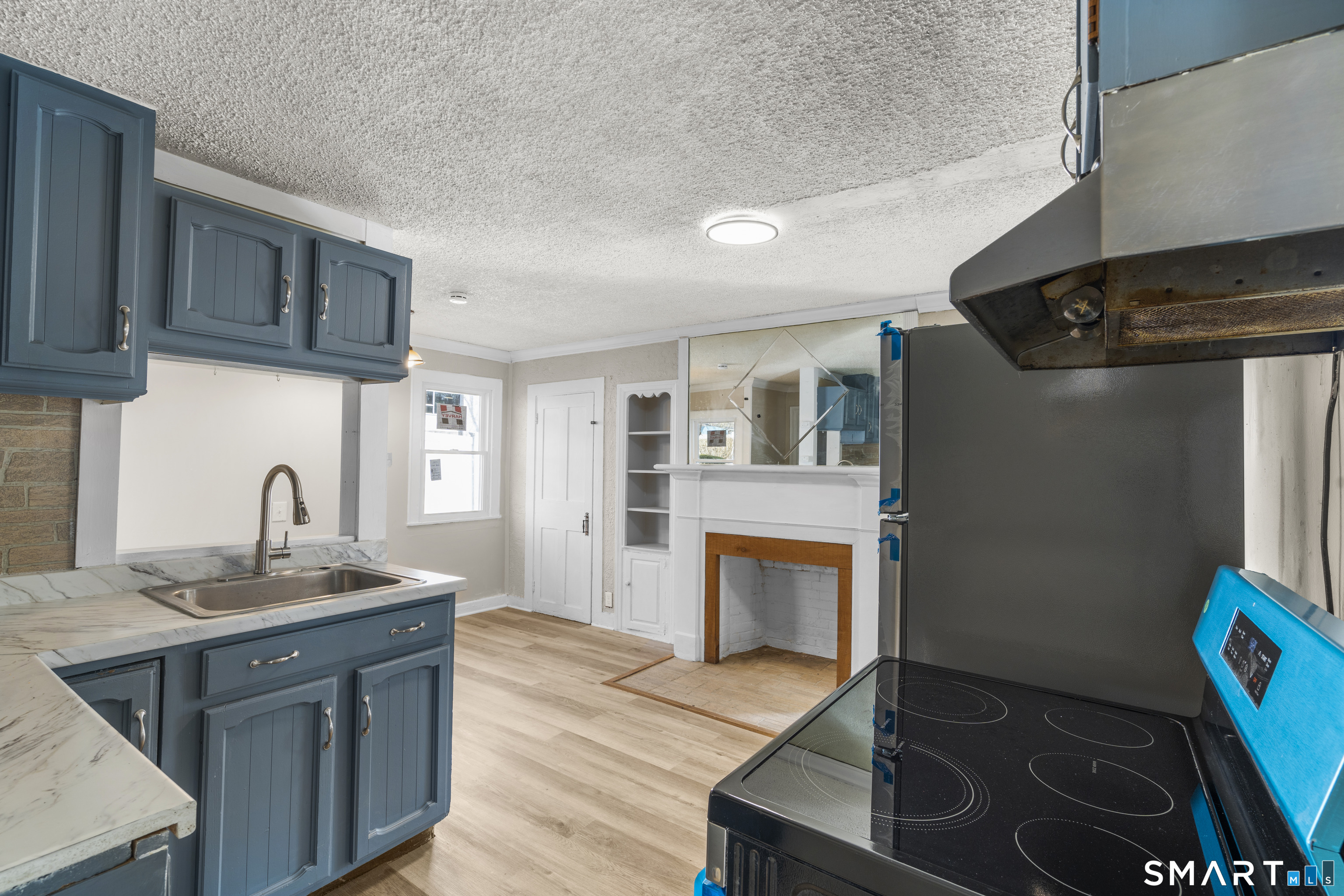 301 Queen Street Bristol, CT 06010 - Photo 9 of 26 a kitchen with granite countertop a sink stove and refrigerator