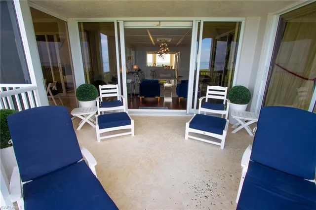 a living room with furniture rug and wooden floor