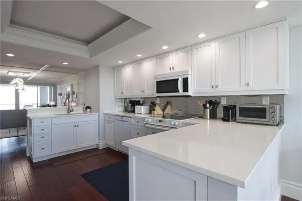 a large white kitchen with white cabinets