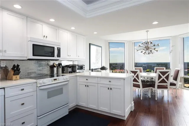 a kitchen with a sink stove and cabinets