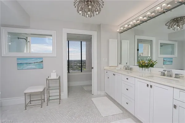 a spacious bathroom with a granite countertop sink a toilet and a mirror