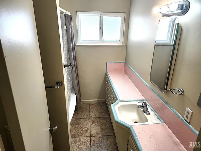 a bathroom with a shower and a sink