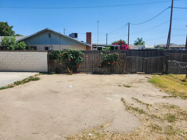 a white house that has a tree in front of it