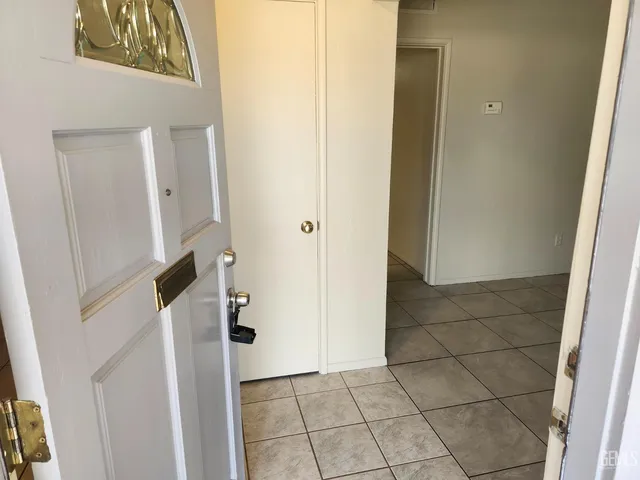 an empty room with windows and fireplace