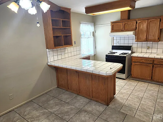 a kitchen with stainless steel appliances a sink and cabinets