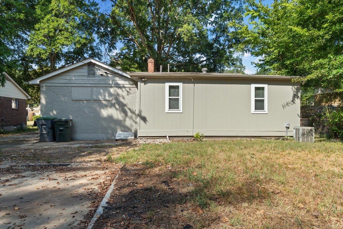 524 McDermitt Road Memphis, TN 38120 - Photo 29 of 32 Exterior featuring horizontal siding, white-framed windows, and a brick-painted section