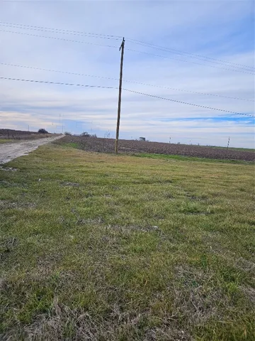 a view of a field with an ocean beach