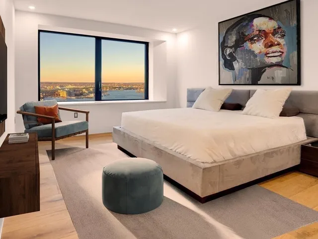 a bedroom with a bed and glass window