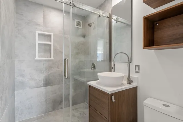 a bathroom with a sink toilet and shower