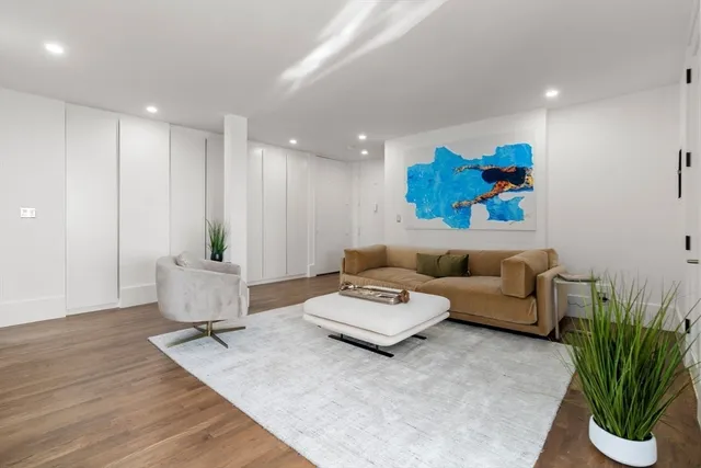 a living room with furniture and a potted plant