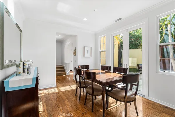 a view of a dining room with furniture and a potted plant
