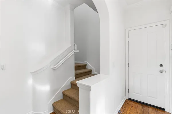a view of entryway and hall with wooden floor