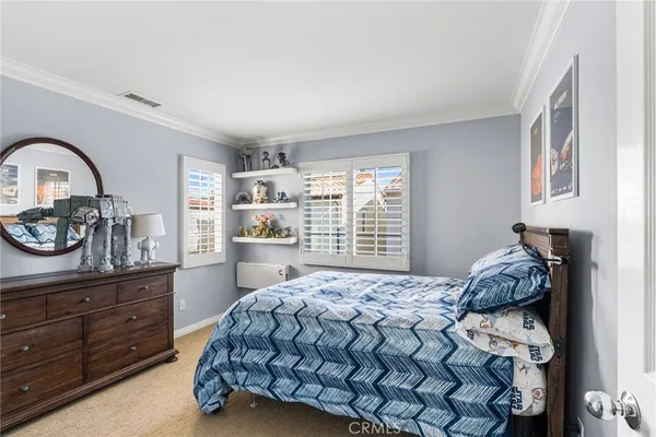 a bedroom with a bed and a closet with window