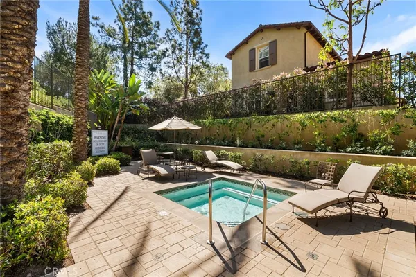 a view of swimming pool with outdoor seating and plants