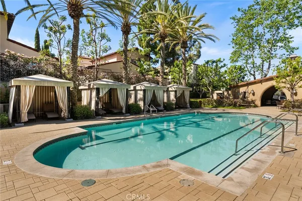 a view of swimming pool with outdoor seating and plants