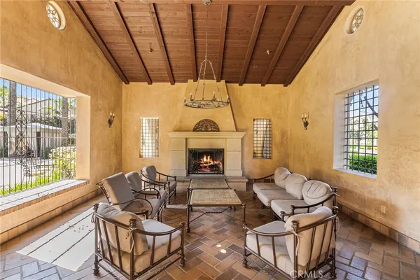 a living room with furniture a fireplace and a table