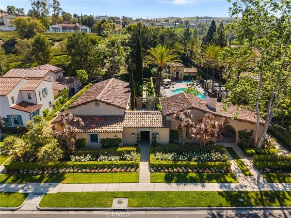 an aerial view of a house with garden space and street view
