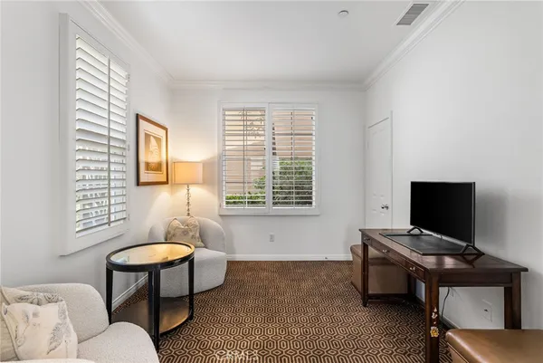 a livingroom with lounge chair and a window
