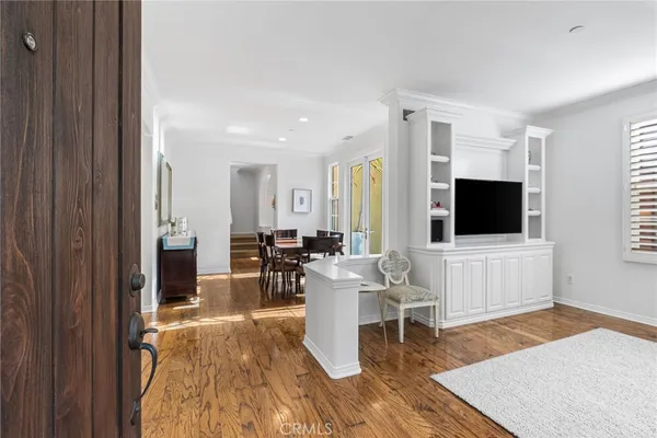a living room with furniture wooden floor and a flat screen tv