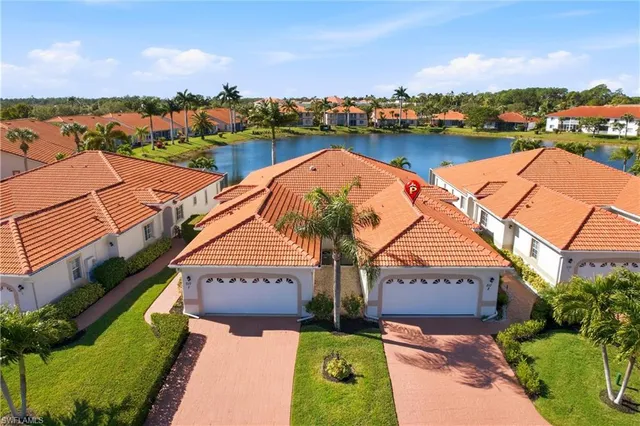 an aerial view of house with yard and lake view