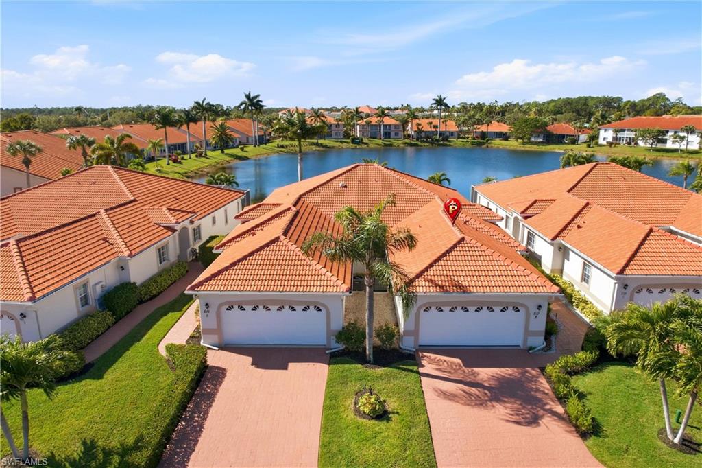 an aerial view of house with yard and lake view