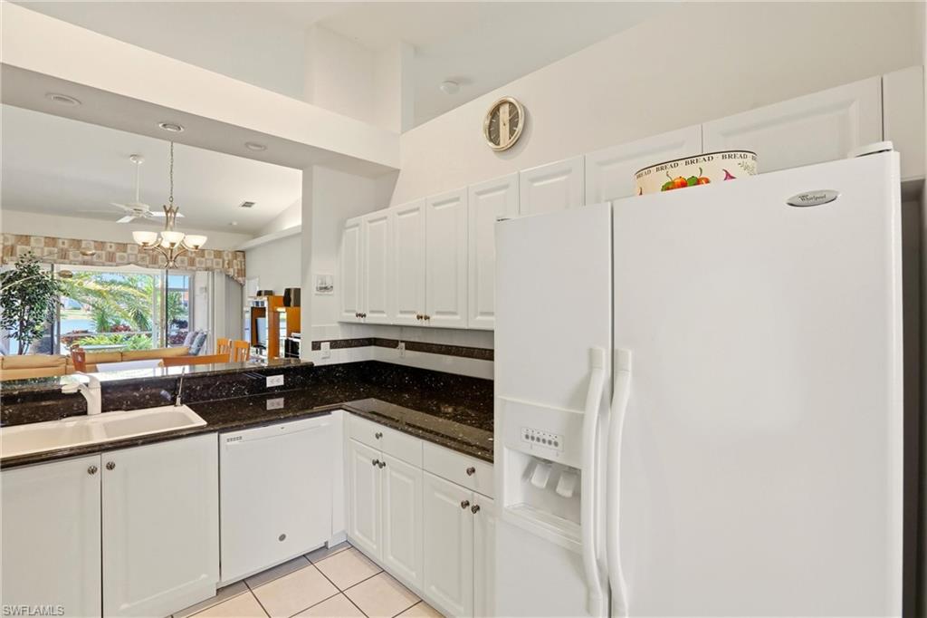 511 Joseph Court, Unit 2 Naples, FL 34104 - Photo 16 of 50 a kitchen with a sink and white cabinets