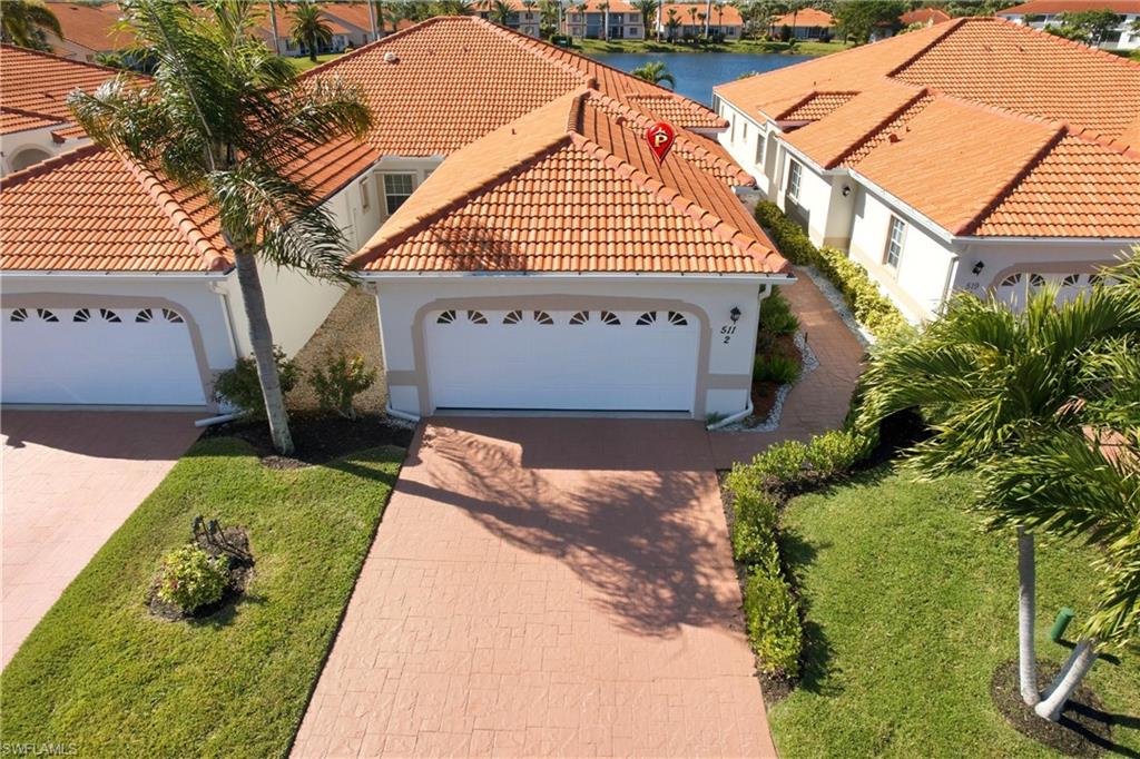511 Joseph Court, Unit 2 Naples, FL 34104 - Photo 2 of 50 a view of front of house with a yard