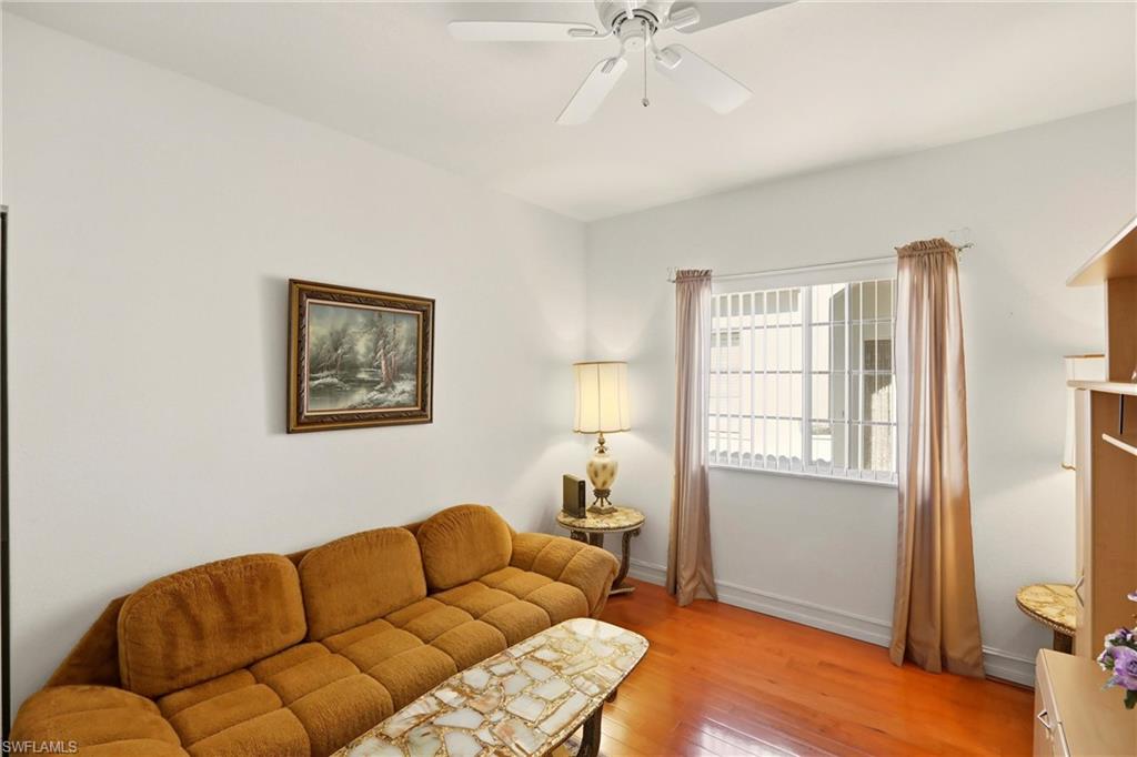 511 Joseph Court, Unit 2 Naples, FL 34104 - Photo 26 of 50 a bedroom with furniture and a window