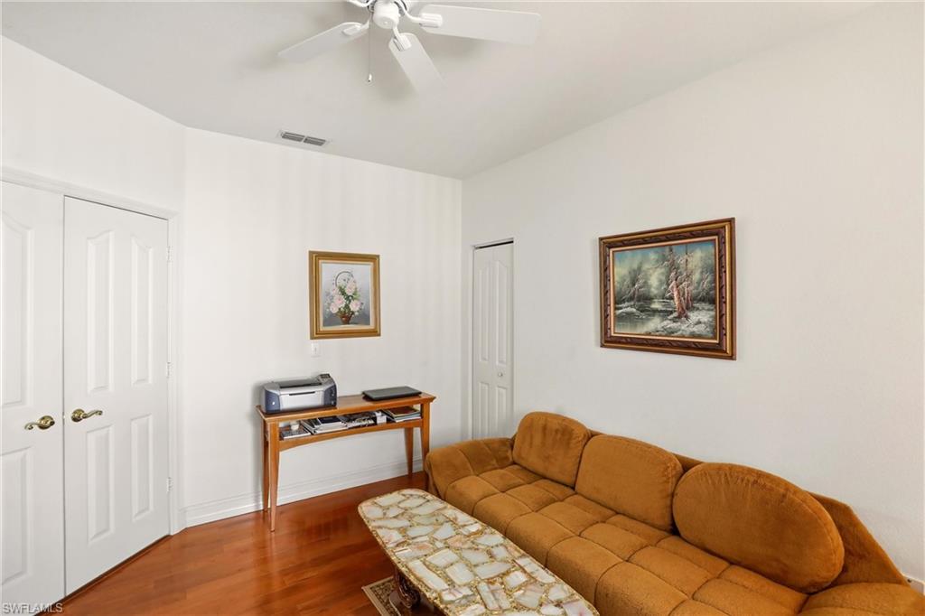 511 Joseph Court, Unit 2 Naples, FL 34104 - Photo 27 of 50 a bedroom with a bed and a couch