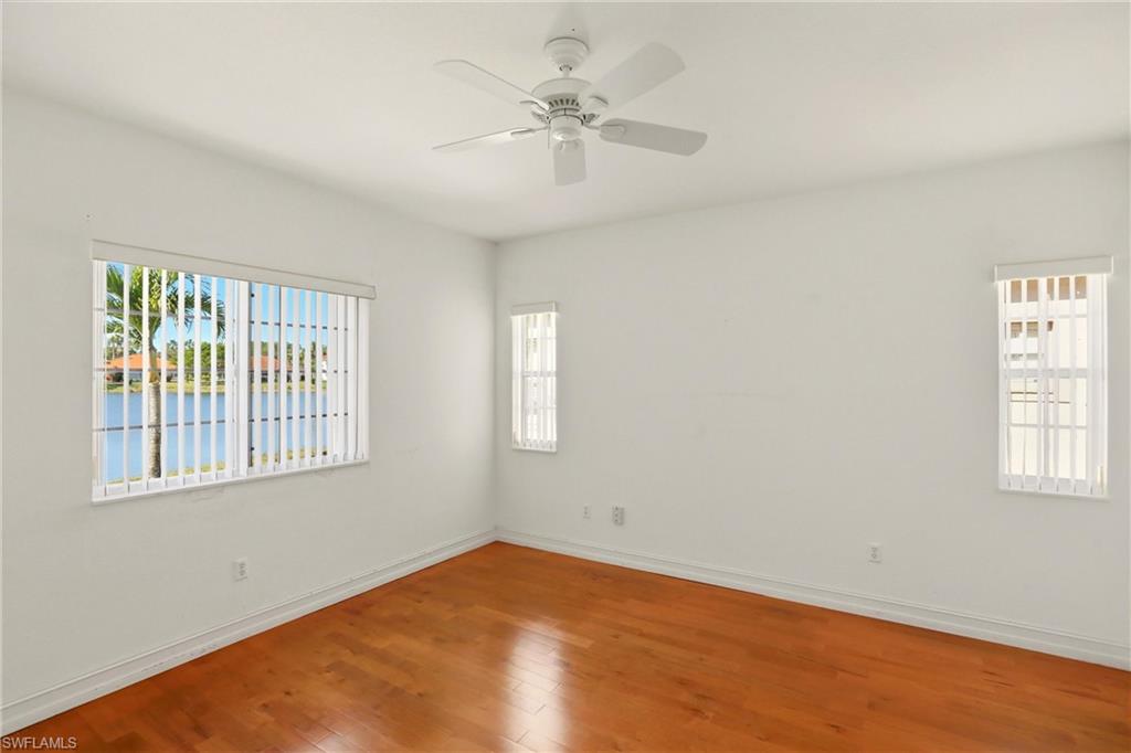 511 Joseph Court, Unit 2 Naples, FL 34104 - Photo 30 of 50 wooden floor in an empty room with a window